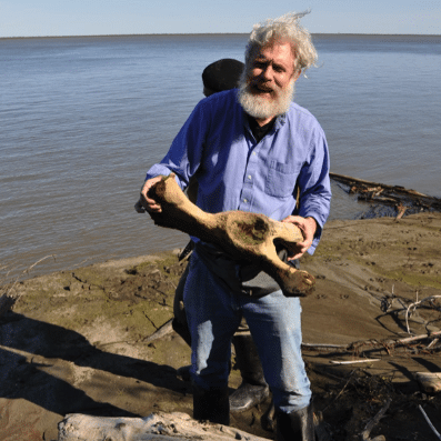 GeorgeChurchwithMammothBone credit_Eriona Hysolli George Church in the field with wolly Mammoth Bone